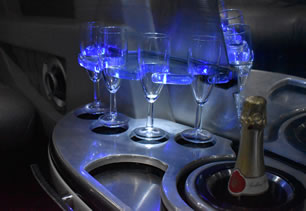Bar with glasses and bubbly for passengers in limo in Blackpool