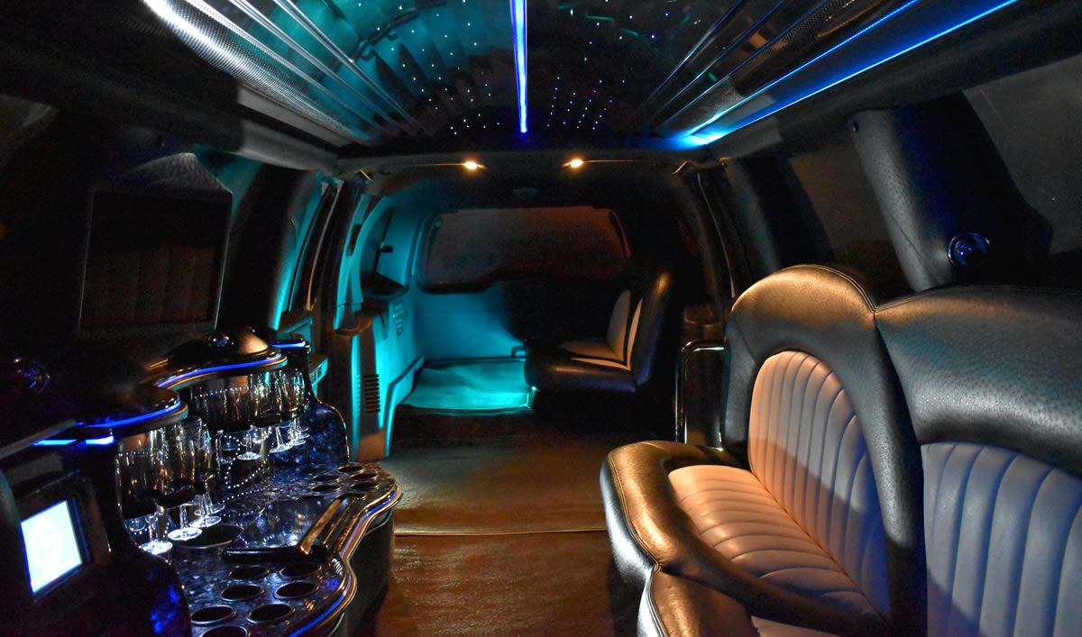 Inside two-tone Tux limo with seats, lights and drinks